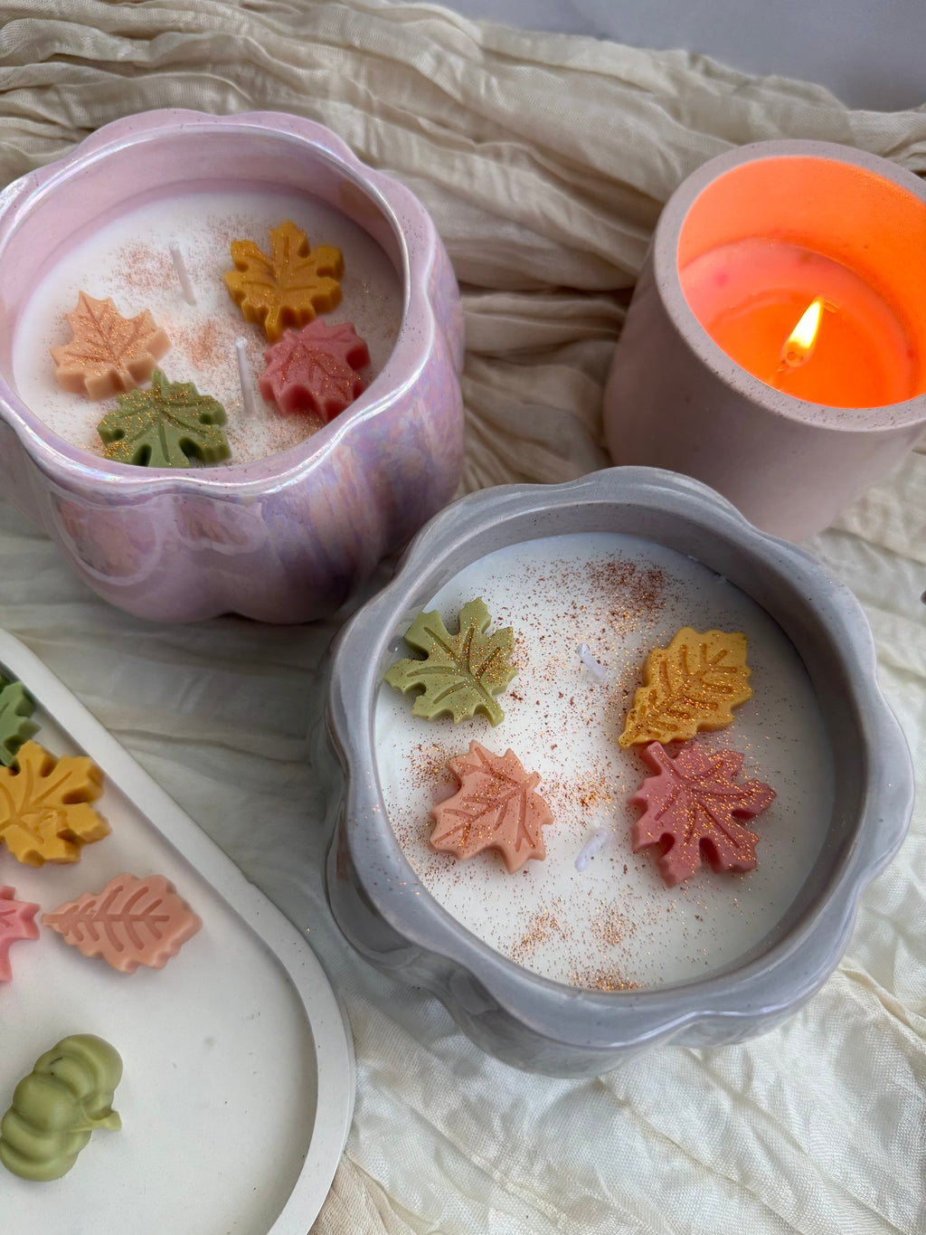 Handmade pumpkin soy candle in a ceramic jar. Cozy fall aroma and elegant design by SiL Candle Atelier.