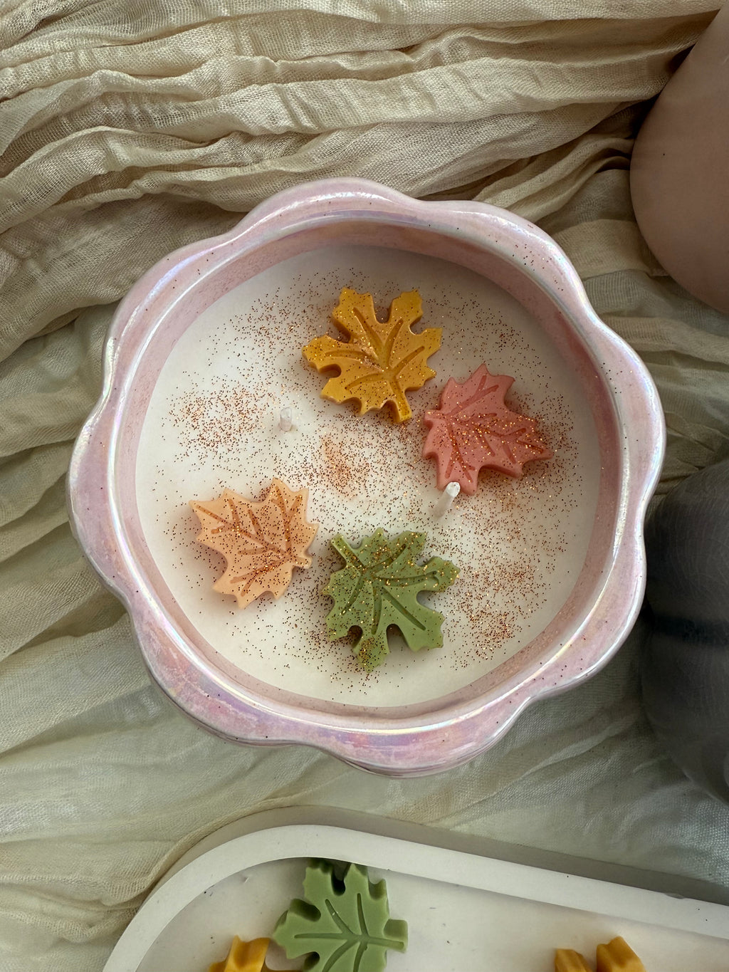 Handmade pumpkin soy candle in a ceramic jar. Cozy fall aroma and elegant design by SiL Candle Atelier.