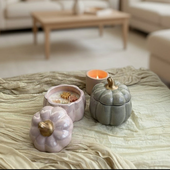 Handmade pumpkin soy candle in a ceramic jar. Cozy fall aroma and elegant design by SiL Candle Atelier.